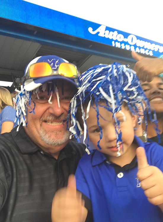 In this undated photo, MTSU alumnus and EMT Scott Storey (Class of 2017) of Mt. Pleasant, Tenn., left, and his youngest son, Ben, enjoy a Blue Raider football game at Floyd Stadium. Storey, now 53, earned his bachelor’s degree in professional studies through MTSU Online, a move that he said ‘pole-vaulted’ his career. (Submitted photo)