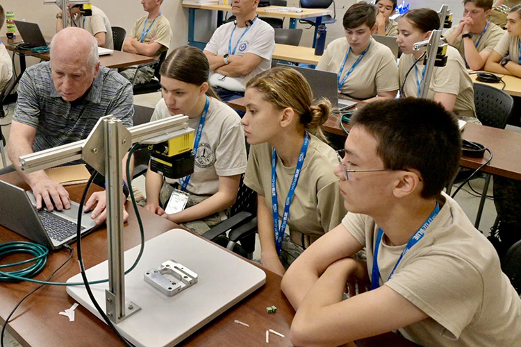 Ken Currie, chair of Middle Tennessee State University’s Department of Engineering Technology, center left, helps a group of Civil Air Patrol cadets Tuesday, July 11, with a laptop-based demonstration inside a classroom in the Voorhees Engineering Technology Building. The group of cadets from all over the country were attending the weeklong National Cadet Engineering Technology Academy, also known as E-Tech, to expose them to a variety of science and engineering fields. (MTSU photo by Andy Heidt)