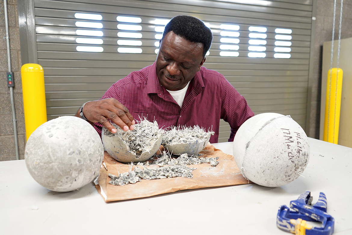 In this spring 2023 photo, Bennie Thompson, a Middle Tennessee State University rising senior concrete industry management major and Honors Transfer Fellow from Fayetteville, Tenn., inspects a collection of concrete balls inside the School and Concrete and Construction Management Building on the MTSU campus. (MTSU photo by Robin E. Lee)