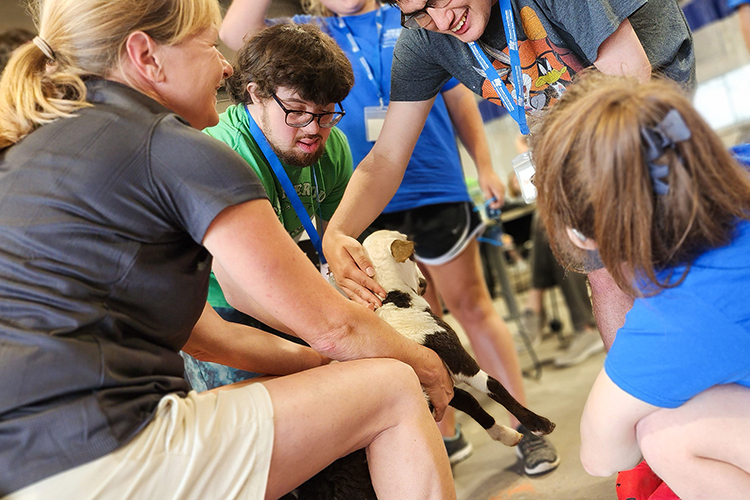 Campers from Middle Tennessee State University’s Inclusive College Experience camp pet a goat with Alanna Vaught, far left, instructor at MTSU’s School of Agriculture, this June on campus. (MTSU photo by Nathan Estus)