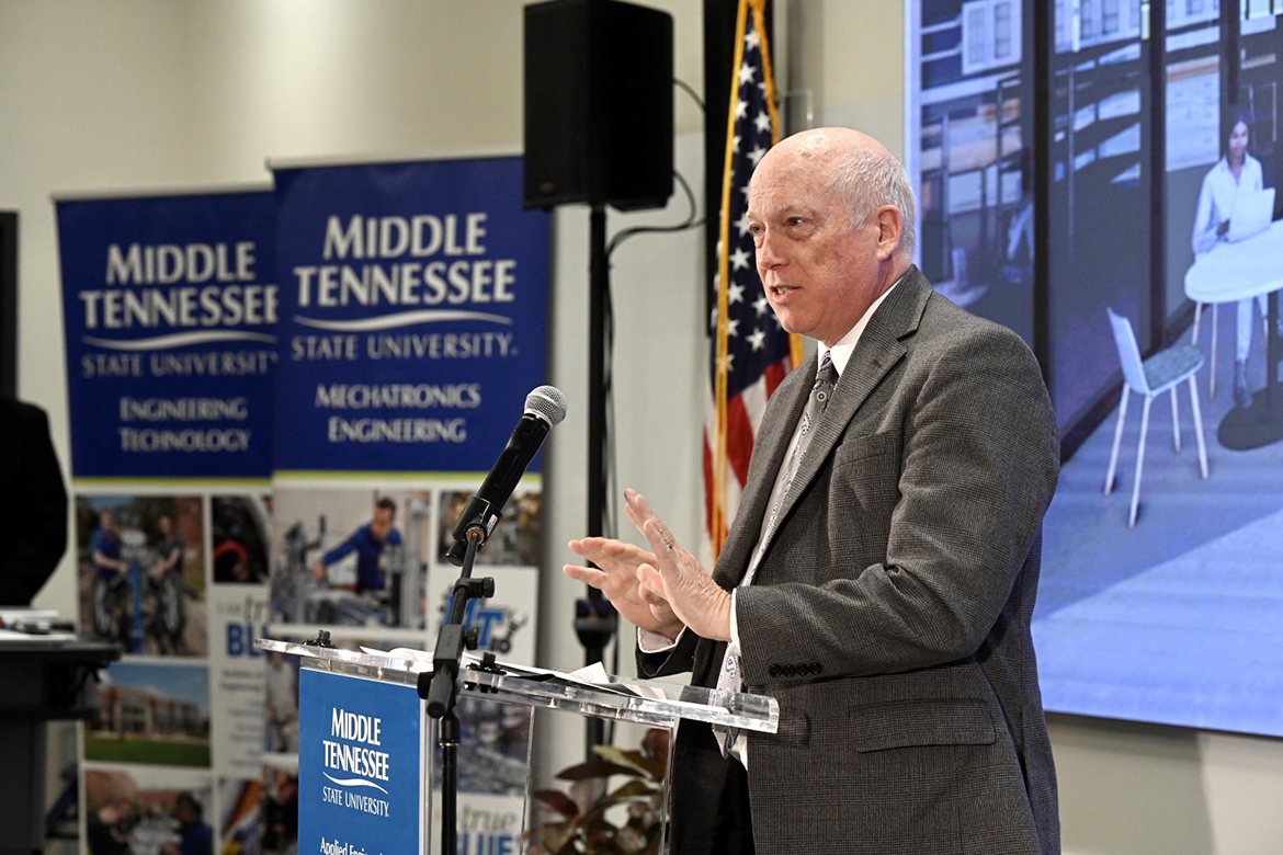 Middle Tennessee State University Department of Engineering Technology Chair Ken Currie tells the audience attending the groundbreaking ceremony for the new Applied Engineering Building that “this building signifies a bridge across generations that is represented by the lives of current students and recent graduates.” Despite rain, which forced the event to be held indoors in a large School of Concrete and Construction Management classroom, a large turnout of students, faculty, staff and special guests attended. (MTSU photo by J. Intintoli)