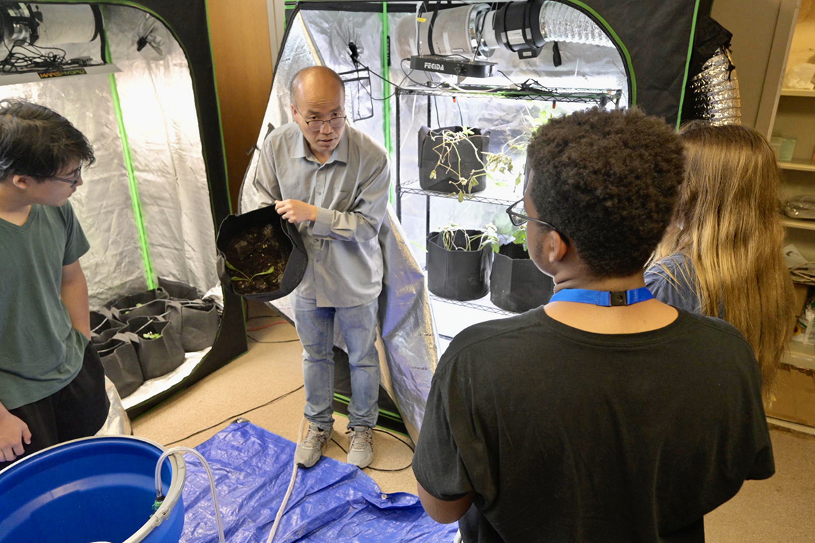 Middle Tennessee State University engineering technology assistant professor Hongbo Zhang, center, explains to College of Basic and Applied Sciences STEM summer camp about his ultraviolet light research in grow tents in the Voorhies Engineering Technology Building. More than 70 high school students attended the second-year camp June 19-23. (MTSU photo by Andy Heidt)