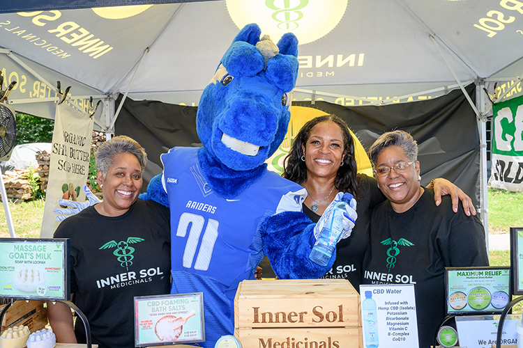 MTSU mascot Lightning visits with representatives from Inner Sol Medicinals at the 2022 Juneteenth Festival in Murfreesboro, Tenn. Middle Tennessee State University will again have representatives staffing information tables at the 2023 street festival Saturday, June 17. (MTSU file photo by James Cessna)