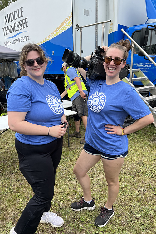 MTSU College of Media and Entertainment students Lane Stanley, left, and Vanessa Dufour are among the live television production crew working at this year’s Bonnaroo Music and Arts Festival. They are in front of MTSU’s almost $2 million Mobile Production Lab, known affectionally as “The Truck,” which will be used to record 25 performances at this year’s four-day event. (MTSU Photo by Andrew Oppmann)