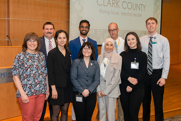 Janna Abou-Rahma, second from right in the front row, an undergraduate student and researcher from Middle Tennessee State University, posed for a photo with her winning teammates and judges of the highly competitive Mayo Clinic Social Determinants of Health Challenge. The challenge is put on in the lead up to the annual National Conferences of Undergraduate Research, held this April at the University of Wisconsin-Eau Claire. Abou-Rahma and her team’s win put her in the top 1% of hundreds of applicants. (Photo courtesy of Janna Abou-Rahma)