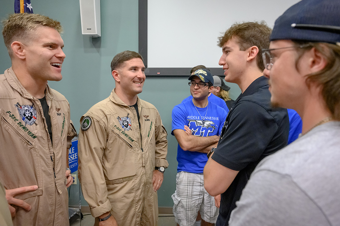 Middle Tennessee State University junior aerospace professional pilot major Carter Biankowski, second from right, of Smyrna, Tenn., chats with U.S. Navy F-35C Demo Team members Lt. Dan “Skap” Barringer, left, and Capt. Matt” Blower” Jackson about their flying careers. Barringer and Jackson are part of the lineup for the 2023 Great Tennessee Air Show June 10-11 at Smyrna Airport. (MTSU photo by J. Intintoli)
