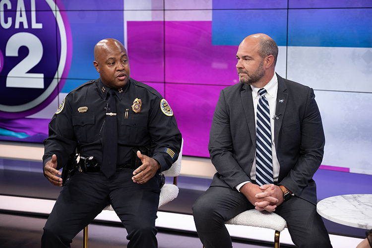 Metro Nashville Assistant Police Chief Dwayne Greene, left, and John Burchfield, associate dean of MTSU University College, appear June 26 on the WKRN News Local on 2 program from the station’s Nashville, Tenn., studios to discuss the benefits of the university’s new public safety concentration geared toward helping working professionals like those on Metro Nashville’s police force earn their bachelor’s degree. (MTSU photo by James Cessna)