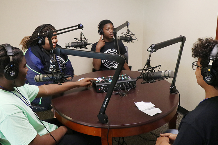 Students from the Boys and Girls Clubs of Rutherford County who joined the recent digital literacy summer camp at Middle Tennessee State University dig into a podcasting opportunity in the Bragg Media and Entertainment Building. The 2023 "Come to Voice" camp, sponsored by the College of Media and Entertainment,  brought 20 seventh through ninth graders to MTSU to learn about podcasting and digital media literacy. (MTSU photo by Lucas Kautzky)