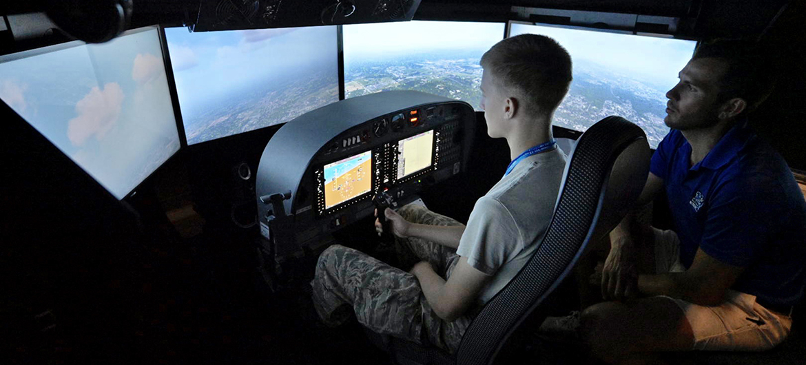 As certified flight instructor Trey Welch, right, looks on, a Civil Air Patrol cadet attending the weeklong National Cadet Engineering Technology Academy, also known as E-Tech, practices on a Department of Aerospace flight simulator Monday, July 10, at Murfreesboro Airport. Middle Tennessee State University again hosted the academy to expose the group of cadets from all over the country to a variety of science and engineering fields. (MTSU photo by Andy Heidt)