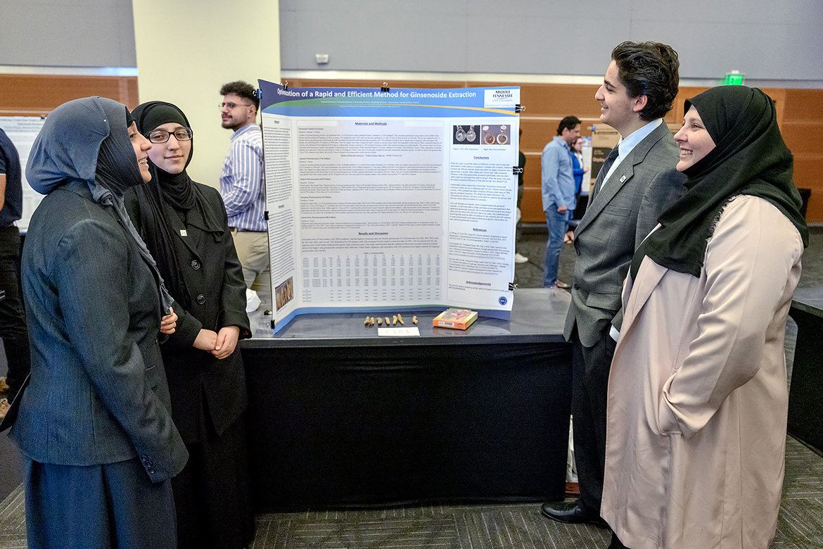 Before becoming full-fledged Middle Tennessee State University students and juniors during the fall 2022 semester, the Alnassari triplets — from left, Zaynab, Fatimah and Ahmed — were MTSU dual-enrollment students while attending the Metro Nashville Public Schools' Virtual School. Shown with their poster titled "Optimization of a Rapid and Efficient Method for Ginsenoside Extraction" and their mother and fellow student Khadiajah Alnassari, they attended the March 2022 Scholars Week finale event. Now 16 and all with driver’s licenses, they are double majoring in premed fields to lead Zaynab and Fatimah to pursue physician assistant programs and Ahmed to medical school. (MTSU file photo by J. Intintoli)