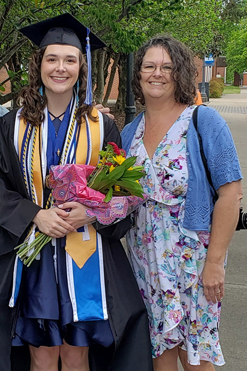 Dressed in her academic regalia for spring 2023 commencement, Catheryn Bolick, left, a Middle Tennessee State University Honors College graduate and Phi Kappa Phi Fellowship recipient from Smyrna, Tenn., and her mother, Kelly, pose for a photo on campus. (Submitted photo)