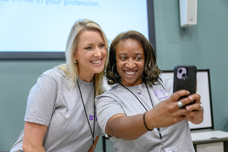 Tiffany Wilson, right, professional school counseling coordinator for Middle Tennessee State University, and April Ebbinger, director of psychological and behavioral supports for the Tennessee Department of Education, pause to take a selfie at the Thursday, July 20, meeting for Project RAISE, the state’s $14 million grant project to retain and recruit mental health professionals into high-needs, rural school districts across the state. Ebbinger brought on Wilson as one of three consultants for the project, and Wilson and MTSU hosted the July meeting at the College of Education building on campus for project staff and its first cohort of interns. (MTSU photo by J. Intintoli)