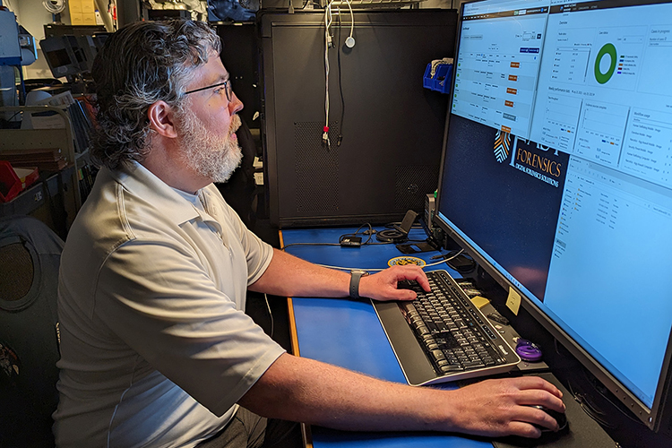 In this undated photo, Middle Tennessee State University summer graduate Chris Brennan, a 29-year veteran of the Metro Nashville Police Department, works at his forensics workstation as a member of the department’s Specialized Investigations Division tech unit. Taking advantage of University College’s Adult Degree Completion Program, Brennan returned to MTSU after decades away to earn his bachelor’s degree in integrated studies. (Submitted photo)