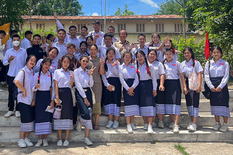 Darrika Morklithavong, alumna of Middle Tennessee State University’s international affairs graduate program, standing front row wearing her tan school uniform, takes a photo with her students and a school principal on the last day of exams this summer during her recently completed Fulbright award work as an English teaching assistant at a local school in her placement city of Savannakhet, Laos. (Submitted photo)