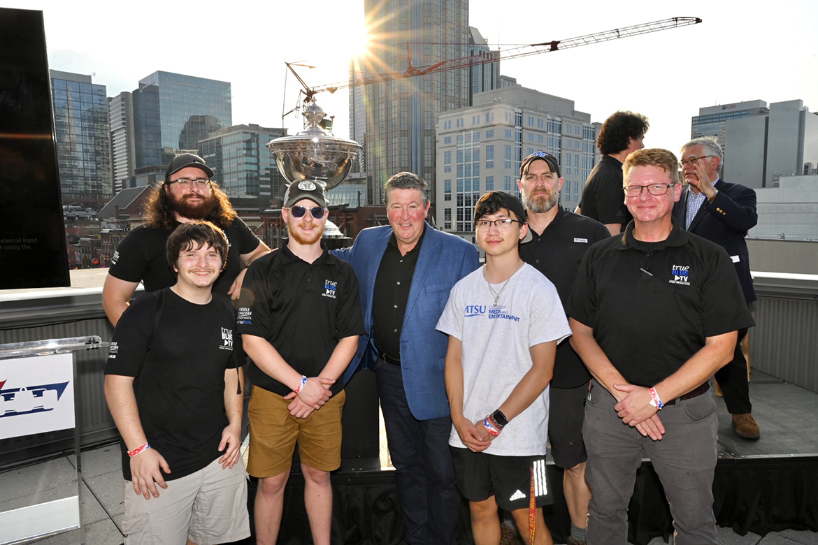 Matt Crews, center, MTSU alumnus, former football player and Big Machine Music City Grand Prix CEO, is shown with the True Blue TV Event Productions team, led by Director Robert Mogensen, right, Thursday Aug. 3, atop Nashville Underground in downtown Nashville, Tenn. They and about 20 College of Media and Entertainment Media Arts Productions students and staff shot video of a live news conference regarding date and track changes for the 2024 Big Machine Music City Grand Prix NTT IndyCar Series event. (MTSU photo by James Cessna)