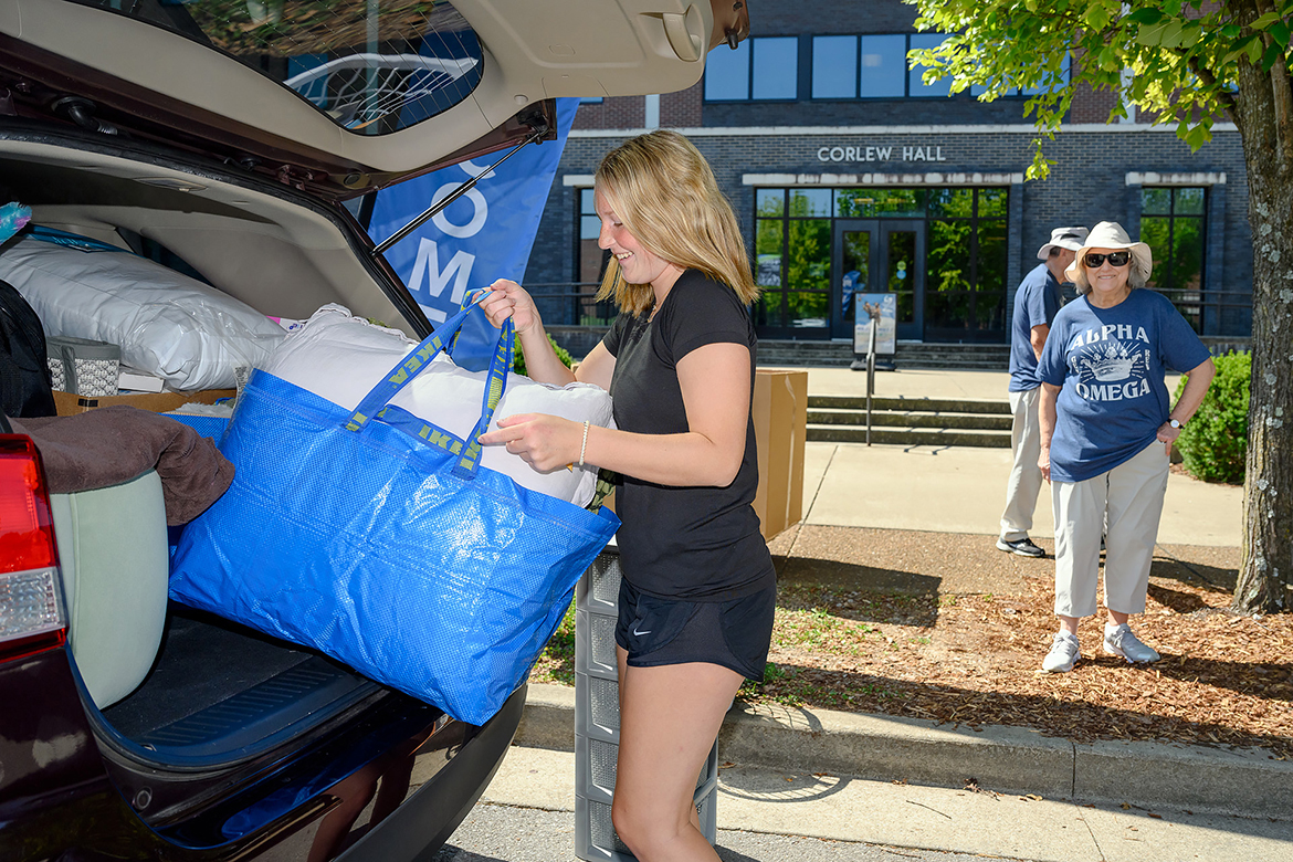bags and items from the family vehicle in front of Corlew Hall on the MTSU campus Wednesday, Aug. 23. MTSU Housing and Residential Life now utilizes staggered times during the week for students to move into residence halls. (MTSU photo by J. Intintoli)