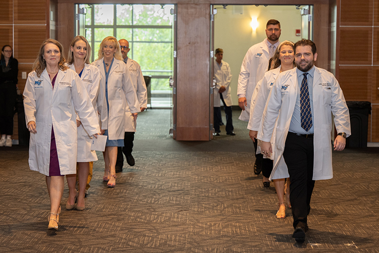 Faculty members of the at Middle Tennessee State University Physician Assistant Studies Program march into the Student Union Ballroom to celebrate their students' transition from classroom to clinic rotations at the inaugural “white coat” ceremony on Aug. 11, 2023. (MTSU photo by James Cessna)