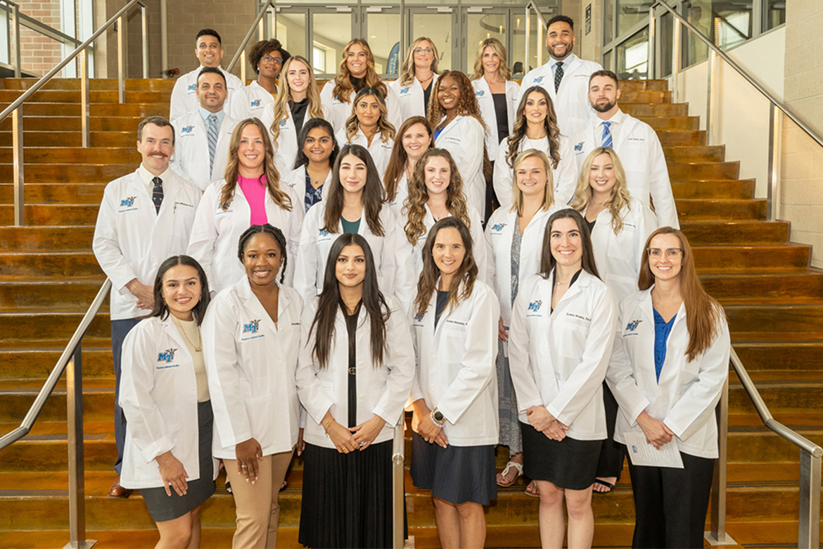 Middle Tennessee State University’s Physician Assistant Studies Class of 2024 pose on the steps of the Student Union Ballroom after the inaugural “white coat” ceremony Aug. 11, 2023, celebrating the transition from classroom to clinic rotations are, front, from left, Joudeline Morales, Jacqueline Asamoah, Liza Samuel, Kristen Mackens, Sydney Brooks and Lisa Lee; second row, from left, John Milstead, Sarah Marsh, Fazeela Babar, Amanda Jack, Rosie Bussey and Sarah Garren; third row, from left, Heena Ismaili and Leanna Collier; fourth row, from left, Muhamed Faour, Christina Tipton, Minahil Choudhry, Joy Oguoma, Maranda Vecchio and Tyler Patton; and fifth row, from left, Sohil Patel, Erin Simms, Macy Murphy, Molly Valentine, Jennifer Hartman and Aidan McGlothan. Students not pictured: Ben Ezell and Daniel Pennington. (MTSU photo by James Cessna)