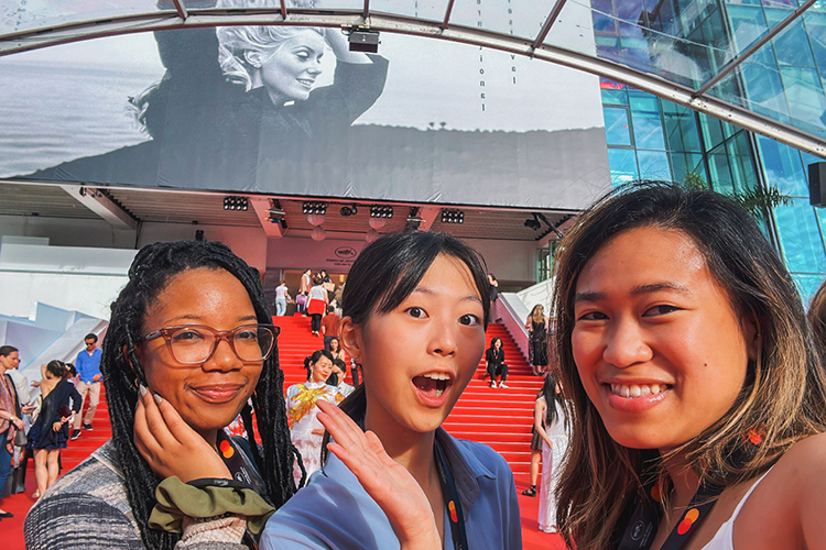 From left, Cannes International Film Festival interns Shelby Geter, Heidy Lee and MTSU alumna Beatriz Marie Dedicatoria (Class of ’20) take a selfie on the steps/red carpet area of the Grand Auditorium Louis Lumière on May 17 in Cannes, France. The interns were attending the morning screening of “Jeanne du Barry,” a French film that premiered at the festival. (Submitted photo)