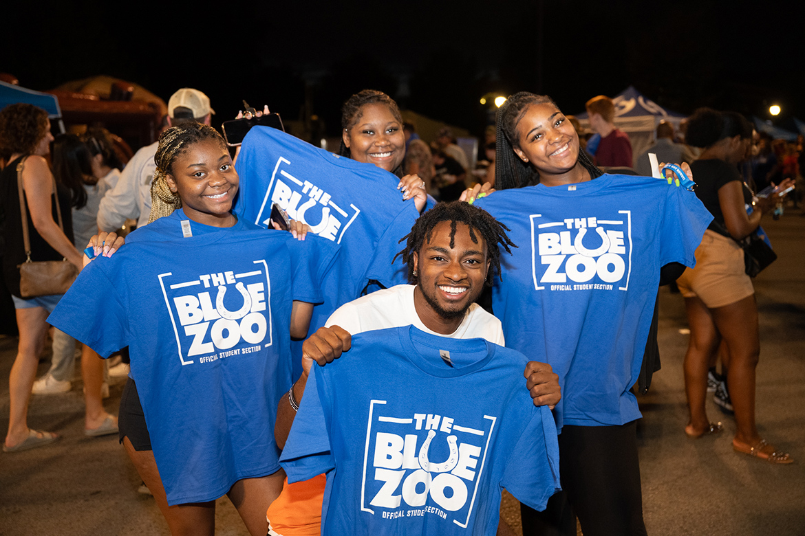 A group of Middle Tennessee State University students show off the Blue Zoo T-shirts they picked up at the Blue Zoo Bash held Sept. 15, 2023, in the Campus Recreation Center lot in support of the student pep organization. (MTSU photo by James Cessna)