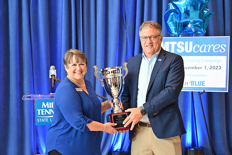 Middle Tennessee State University Provost Mark Byrnes, right, takes back possession of the Provost Cup from Joyce Heames, dean of the Jennings A. Jones College of Business, which has captured the cup 10 straight years for having the highest percentage of participation among the academic colleges during the annual Employee Charitable Giving Campaign. This year's campaign kicked off Wednesday, Sept. 27, in the Cope Administration Building lobby. (MTSU photo by James Cessna)