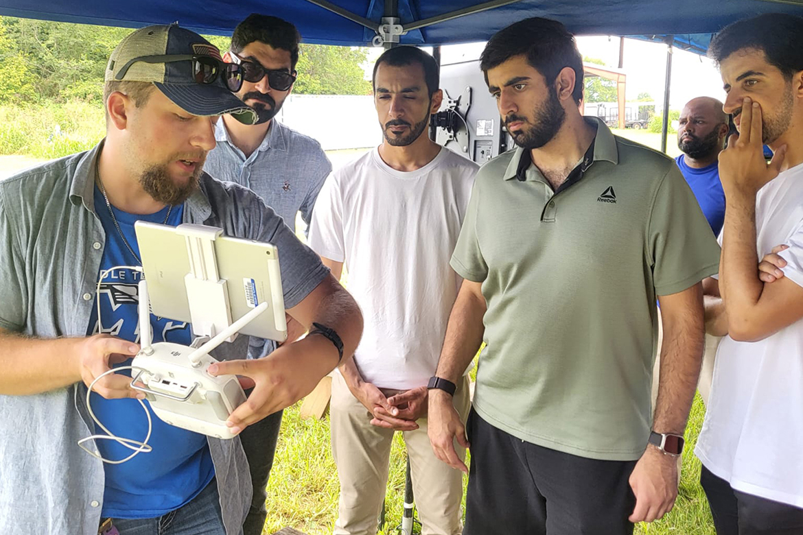 Cameron Barnes, a recent MTSU Unmanned Aircraft Systems Operations graduate, shows members of the Dubai Police Force students participating in the Business Analytics and Forensic Science Global Study program at Middle Tennessee State University in August how the controls work on one of the university’s drones. (MTSU photo by Rehab Ghazal)