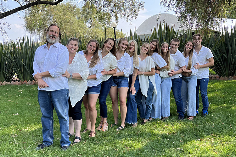 The whole Fisher family of 12 — a mother, father and their 10 children — take a photo together in Guadalajara, Mexico, during a family reunion this year. Standing, from left, are parents Paul and Dawn Fisher and their children Amanda, Natasha, Gwendolyn, Penellope, Daphne, Calliope, Gabriela, Joseph, Raquel and Jack. Five of the 10 siblings, Amanda, Calliope, Gabriela, Joseph and Raquel, now attend Middle Tennessee State University in Murfreesboro, Tennessee, together where they meet up for study dates and support each other in their True Blue experience. (Submitted photo)