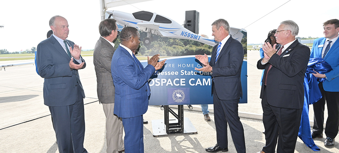 From left, Middle Tennessee State Board of Trustees Chair Steve Smith, Tennessee Rep. Cameron Sexton, MTSU President Sidney A. McPhee, Gov. Bill Lee and Shelbyville Mayor Randy Carroll unveil the promotional sign for MTSU's new Aerospace Campus at Shelbyville Municipal Airport during the special event Thursday, Sept. 21, to announce the Aerospace Department's eventual move to the airport. (MTSU photo by J. Intintoli)