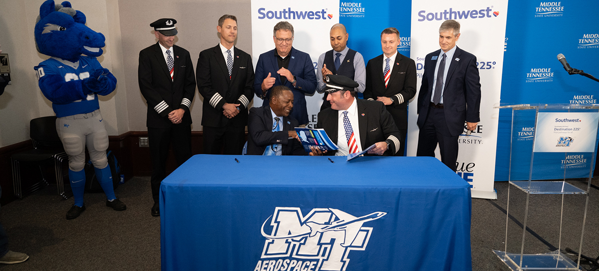 Middle Tennessee State University President Sidney A. McPhee, left, and Southwest Airlines Capt. Brad Monda shake hands after signing documents cementing the partnership as MTSU becomes part of the airline’s Destination 225° program Wednesday, Sept. 6, in the Business and Aerospace Building’s State Farm Lecture Hall. Acknowledging the agreement are back row, from left, MTSU mascot Lightning, Southwest Capts. Sean Strittmatter and Justin Peele, MTSU Provost Mark Byrnes and Aerospace Chair Chaminda Prelis. The program includes pathways for pilots who are just starting to fly, those working on university degrees and those already building time toward their Airline Travel Pilot certificate. (MTSU photo by James Cessna)
