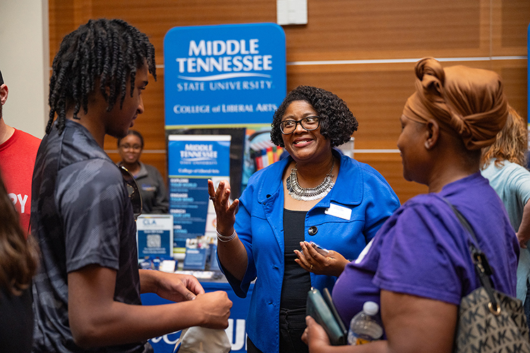 Leah Lyons, center, dean of the College of Liberal Arts at Middle Tennessee State University, shares about her college’s programs with prospective students and their families at the kickoff event for the True Blue Tour on Wednesday, Sept. 13, 2023, at the Student Union Ballroom on the campus in Murfreesboro, Tenn. (MTSU photo by Cat Curtis Murphy)