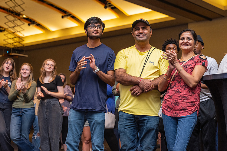 Prospective Middle Tennessee State University student Neil Gandhi, left, along with his parents Jay Gandhi, center, and Jigna Gandhi, watch MTSU President Sidney A. McPhee’s address at the university’s kickoff event for the True Blue Tour on Wednesday, Sept. 13, 2023, at the Student Union Ballroom on campus in Murfreesboro, Tenn. (MTSU photo by Cat Curtis Murphy)