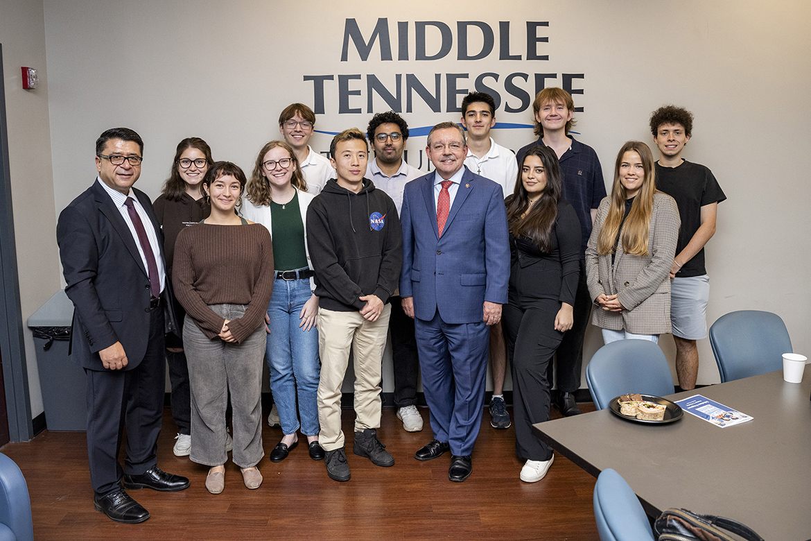 Tennessee Housing Development Agency Executive Director Ralph Perrey, center right wearing tie, takes a group photo with students in the MTSU Chair of Excellence in Urban and Regional Planning’s Scholars Program following his guest lecture Sept. 29 in the Business and Aerospace Building at Middle Tennessee State University. At far left is chairholder Murat Arik. (MTSU photo by Andy Heidt)