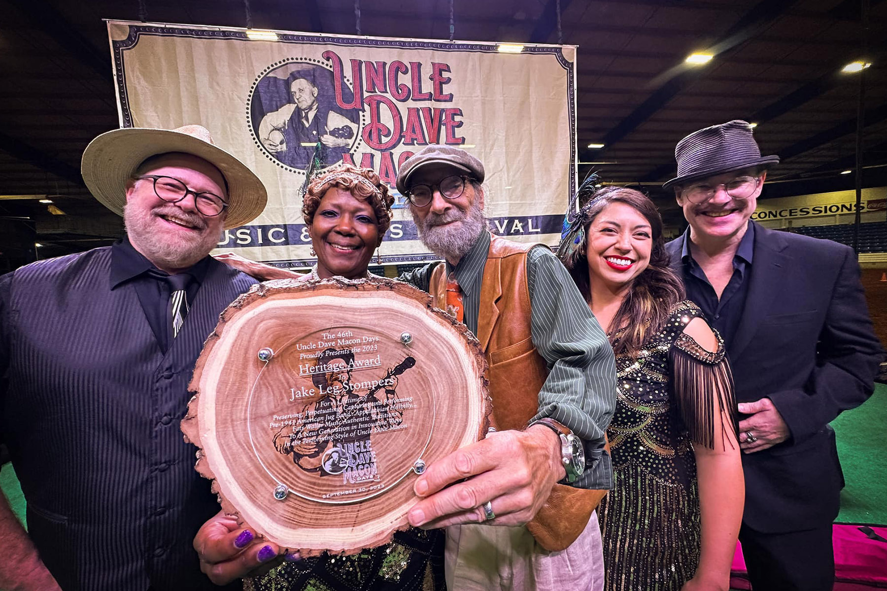 Jake Leg Stompers hold the Uncle Dave Macon Days Heritage Award at the Oct. 1, 2023, event. Members are, from left, Bill "Hambone Willie Nevil" Steber, Lisa “Lela Mae Smith” Fatzinger, Ron "Jersey Slim Hawkins" Bombardi, Heather “Sweet Marie Sultana” Moulder, and Sammy “Ramshackle Jack Dunshee” Baker. Sam “Horatio Algernon Whiplash” Rorex was unable to attend. (Submitted photo)