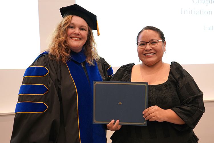 MTSU Associate Dean of the College of Graduate Studies Amy Harris, left, presents the Phi Kappa Phi initiation certificate to Rosa Delgado, a business administration major, at the Phi Kappa Phi fall induction ceremony Oct. 20, 2023, at Middle Tennessee State University. (MTSU photo by Robin E. Lee)