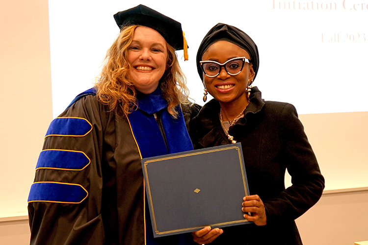 MTSU Associate Dean of the College of Graduate Studies Amy Harris, left, presents the Phi Kappa Phi initiation certificate to Lateefat Amao, a professional science major, at the Phi Kappa Phi fall induction ceremony Oct. 20, 2023, at Middle Tennessee State University. (MTSU photo by Robin E. Lee)