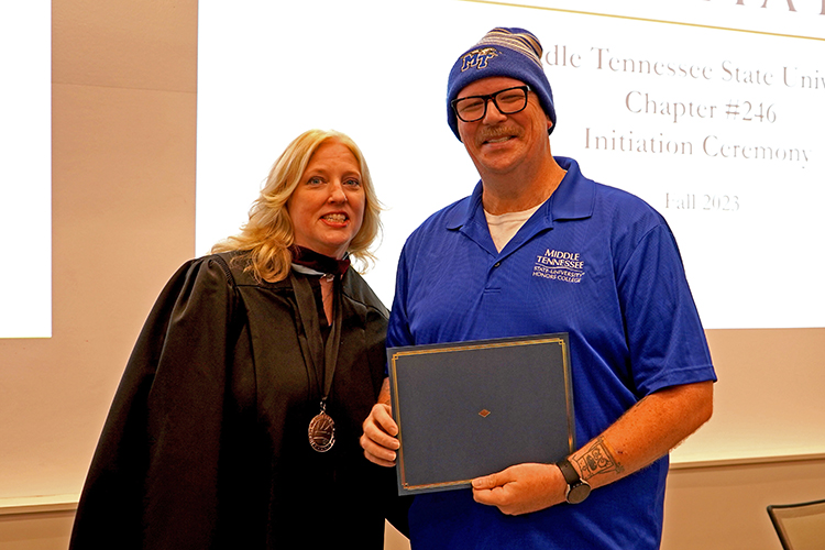 MTSU College of Media and Entertainment Dean Beverly Keel, left, presents the Phi Kappa Phi initiation certificate to Brian Maxwell, a video and film production major, at the Phi Kappa Phi fall induction ceremony Oct. 20, 2023, at Middle Tennessee State University. (MTSU photo by Robin E. Lee)