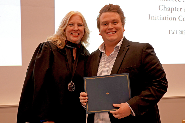 MTSU College of Media and Entertainment Dean Beverly Keel, left, presents the Phi Kappa Phi initiation certificate to Samuel Baldwin, and audio production major, at the Phi Kappa Phi fall induction ceremony Oct. 20, 2023, at Middle Tennessee State University. (MTSU photo by Robin E. Lee)