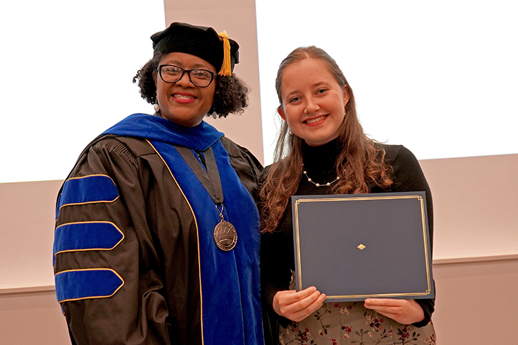 MTSU College of Liberal Arts Dean Leah Lyons, left, presents the Phi Kappa Phi initiation certificate to Jael Guest, a foreign languages major, at the Phi Kappa Phi fall induction ceremony Oct. 20, 2023, at Middle Tennessee State University. (MTSU photo by Robin E. Lee)