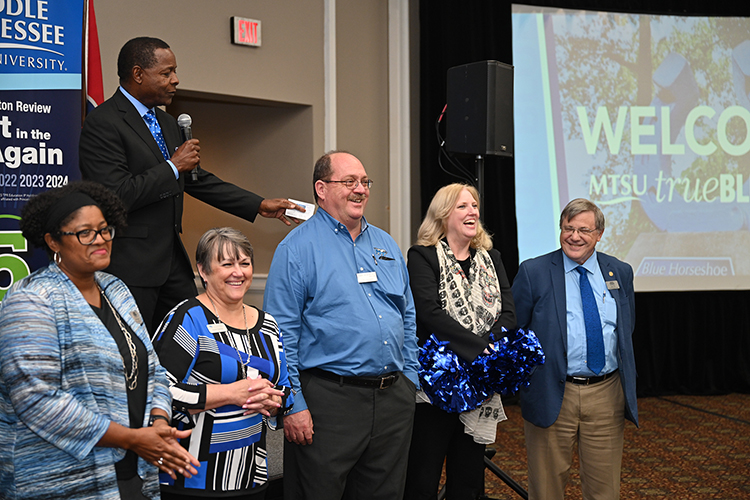 Middle Tennessee State University President Sidney A. McPhee, on stage, introduces his academic deans and leaders to the crowd during MTSU’s True Blue Tour recruitment stop for prospective students at the Millennium Maxwell House Hotel in Nashville, Tenn., on Oct. 3, 2023. Standing, from left, are Leah T. Lyons, dean of the College of Liberal Arts; Joyce Heames, dean of the Jennings A. Jones College of Business; Michael Hein, interim dean of the College of Behavioral and Health Sciences; Beverly Keel, dean of the College of Media and Entertainment; and John Vile, dean of University Honors College. (MTSU photo by James Cessna)