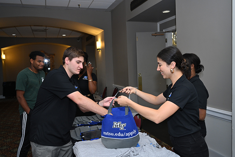 Middle Tennessee State University staff ready goodie bags for prospective students attending the university’s True Blue Tour recruitment event at the Millennium Maxwell House Hotel in Nashville, Tenn., on Oct. 3, 2023. (MTSU photo by James Cessna)
