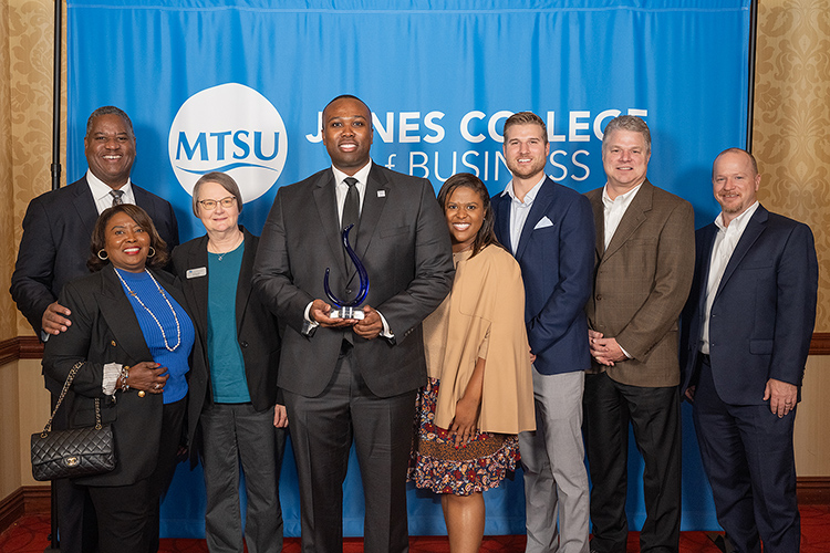 Middle Tennessee State University alumnus Charles Avent Jr., center left holding award, poses with family and supporters at the Jones College of Business Leadership Awards Ceremony held Oct. 19, 2023, at Embassy Suites in Murfreesboro, Tenn. Avent Jr. received the 2023 Young Professional of the Year Award. (MTSU photo by Cat Curtis Murphy)