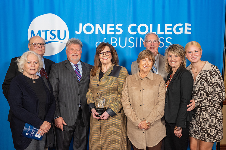 Middle Tennessee State University alumna Lisa Nix , center holding award, poses with family and supporters at the Jones College of Business Leadership Awards Ceremony held Oct. 19, 2023, at Embassy Suites in Murfreesboro, Tenn. Nix received the 2023 Joe M. Rodgers Spirit of America Award (MTSU photo by Cat Curtis Murphy)