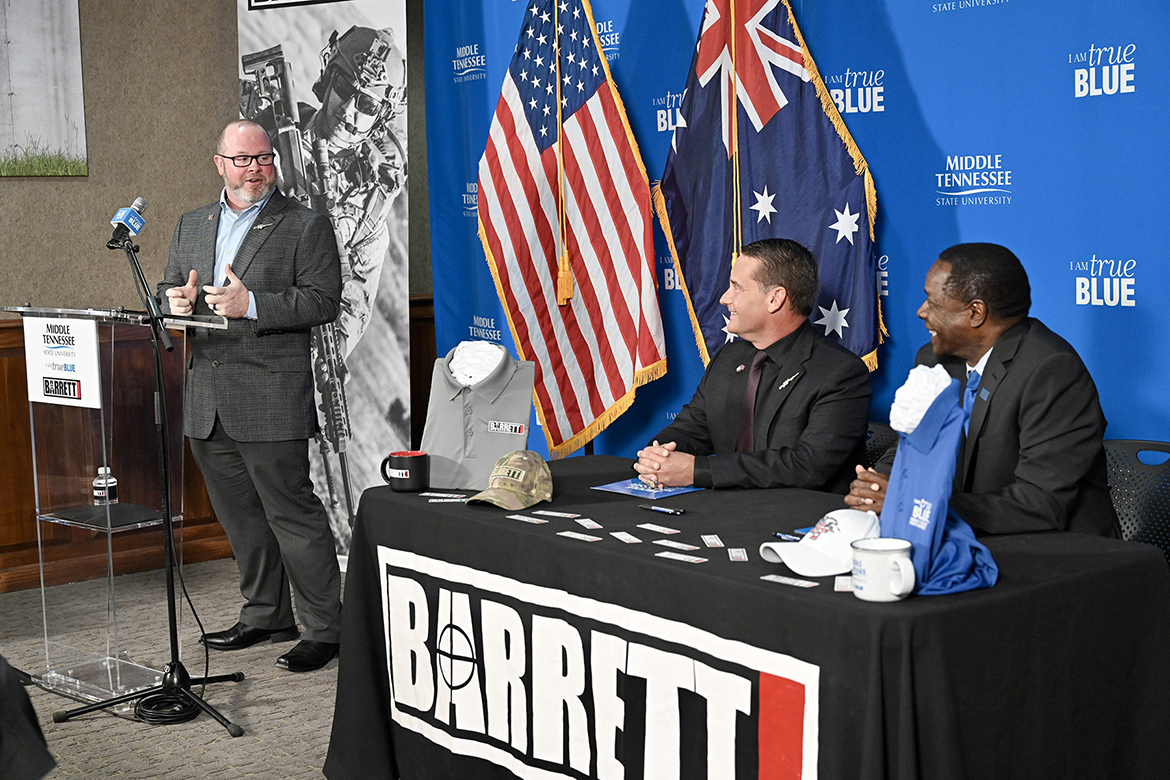 David Gravely, left, director of quality at Barrett Firearms Manufacturing Inc. in Christiana, Tenn., talks about his positive experience thus far as a Middle Tennessee State University student during a signing ceremony Monday, Nov. 6, at Barrett formalizing the new partnership that provides tuition assistance to eligible Barrett employees taking courses at MTSU. Gravely is one of the first employees to take advantage of the program. Also shown are MTSU Sidney A. McPhee, far right, and Joel Miller, vice president for sales and marketing for Barrett. (MTSU photo by J. Intintoli)