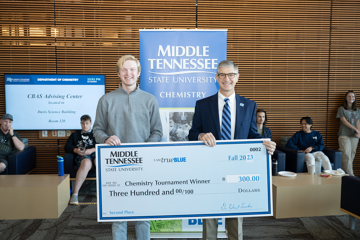 Page High School senior Evan Ingmire, left, of Franklin, Tenn., placed second and won a $1,500 scholarship and $300 cash prize, presented by Middle Tennessee State University College of Basic and Applied Sciences Dean Greg Van Patten in the recent MTSU Department of Chemistry Tournament, held in the MTSU Science Building. (MTSU photo by James Cessna)