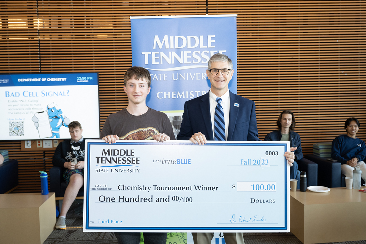 Jackson “Jack” Stinson, left, a senior at Summit High School in Spring Hill, Tenn., receives his third-place award from Middle Tennessee State University College of Basic and Applied Sciences Dean Greg Van Patten at the end of the annual MTSU Chemistry Tournament, held recently in the Science Building. Stinson was the top junior last year. (MTSU photo by James Cessna)