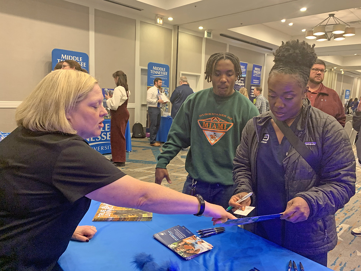 Middle Tennessee State University Office of Housing and Residential Life Director Michelle Safewright, left, assists a son and his mother during the recent MTSU True Blue Tour prospective student recruiting event at the DoubleTree by Hilton in Birmingham, Ala. (MTSU photo by Randy Weiler)