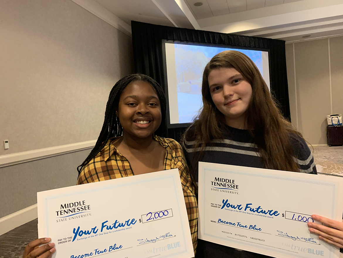 Holding the Middle Tennessee State University scholarships they received at the MTSU True Blue Tour event recently at The Westin in Huntsville, Ala., Amahah Pryor-Wells, left, and Haileigh Hines are set on becoming Blue Raiders next fall. They both plan to major in video and film production in the College of Media and Entertainment. (MTSU photo by Randy Weiler)