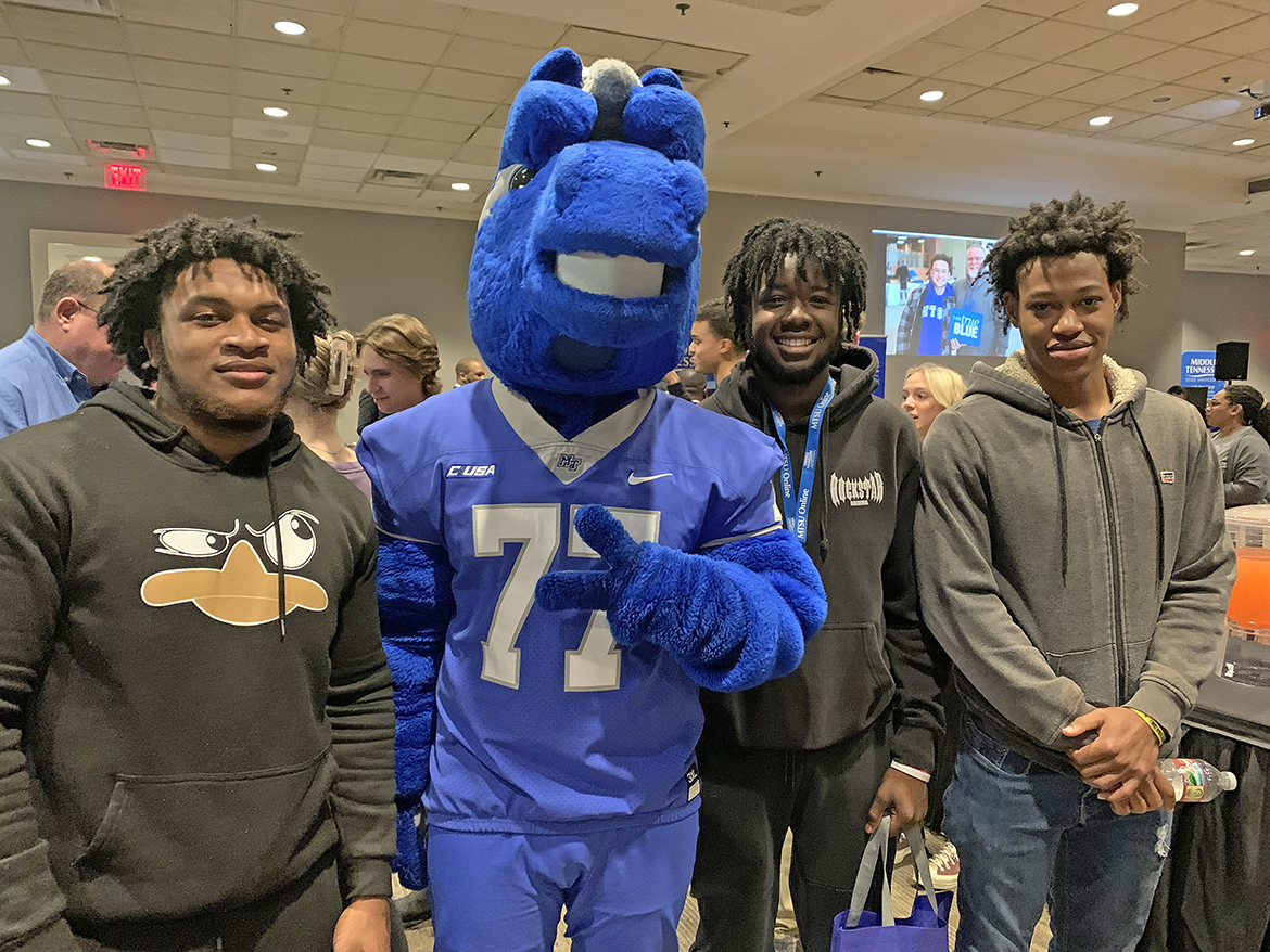 Middle Tennessee State University mascot Lightning finds new friends in Xedarion Miller, left, Andros Simmons and Javen Jones, all seniors at Haywood County High School in Brownsville, Tenn. Along with others from around the region, they attended the MTSU True Blue Tour event to recruit prospective students at the Jackson (Tenn.) Country Club. (MTSU photo by Randy Weiler)
