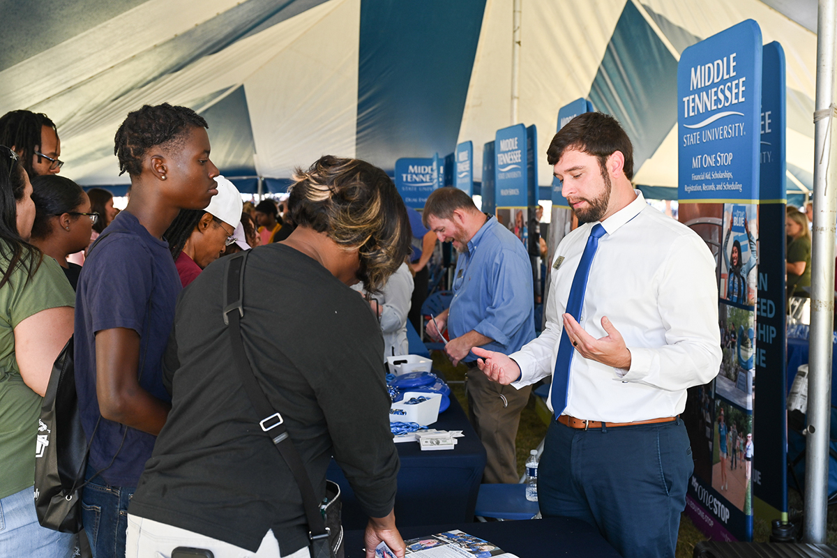 Alex Ray, right, an undergraduate recruiter in the Middle Tennessee State University Admissions Office, answers questions from a prospective student and parent Sept. 30 during the True Blue Preview Day in the Student Union Courtyard. The final preview day of the fall begins at 9 a.m. Saturday, Nov. 4, in the Student Union Building. (MTSU file photo by James Cessna)