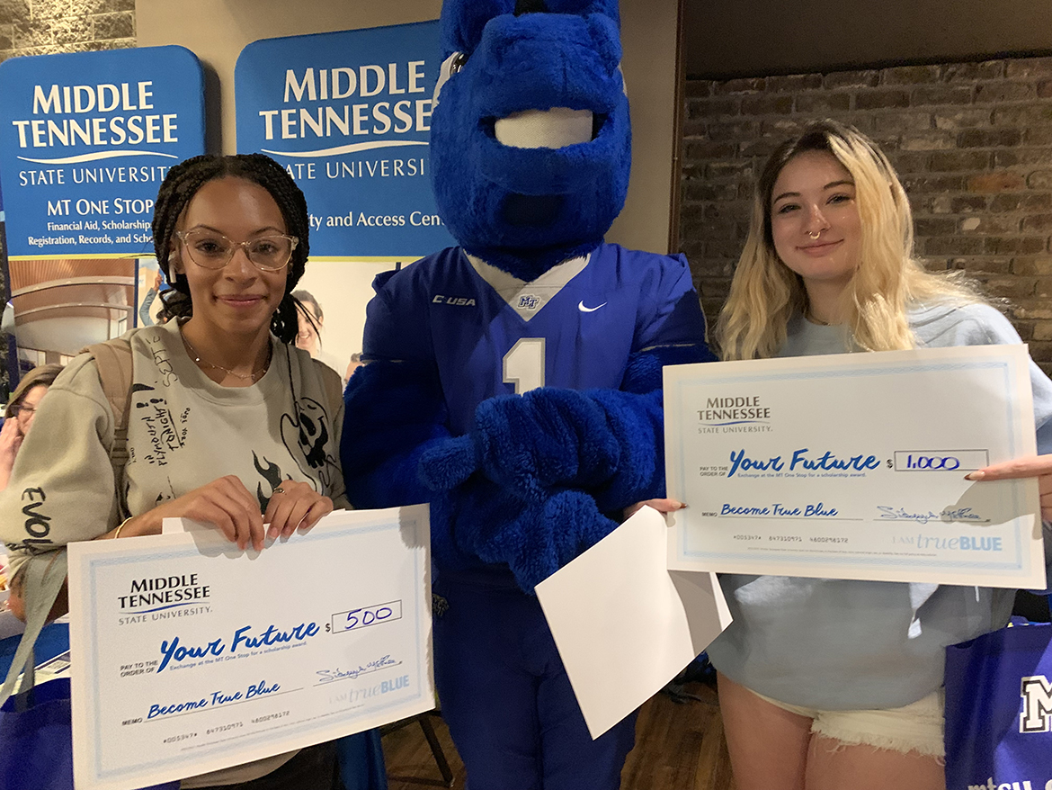 Shown posing with Middle Tennessee State University mascot Lightning, center, best friends and West High School students Nadia Johnson, left, and Ariyana Benoit were among the scholarship recipients attending the MTSU True Blue Tour event Oct. 24 at The Foundry On the Fair Site in Knoxville, Tenn. (MTSU photo by Randy Weiler)